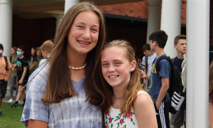 Two students smile